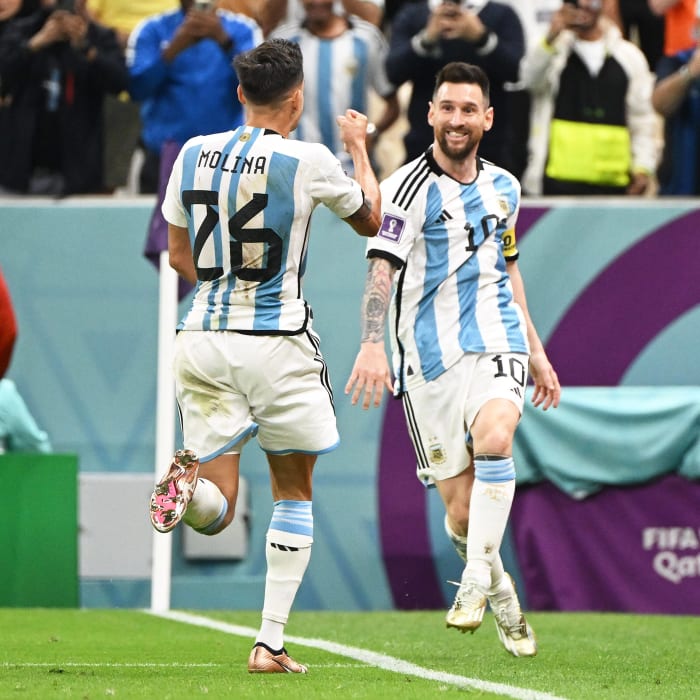 Lionel Messi pictured (right) celebrating with Nahuel Molina after an Argentina goal against Holland at the 2022 World Cup